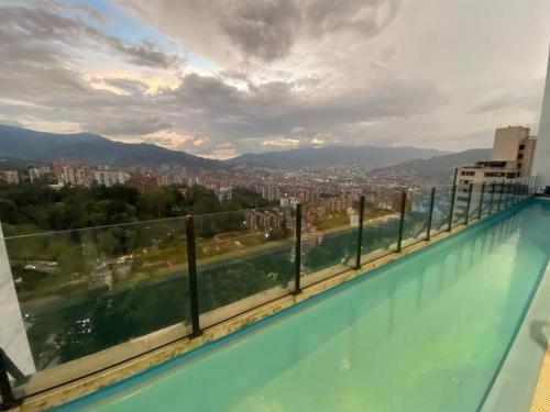 a swimming pool with a view of a city at penthouse luxurytravelhome poblado in Medellín