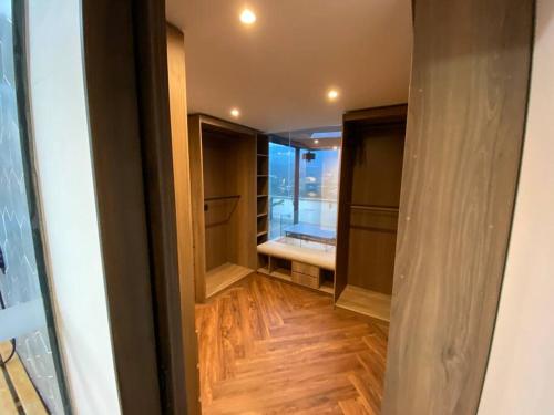 a room with a walk in closet with wooden floors at penthouse luxurytravelhome poblado in Medellín