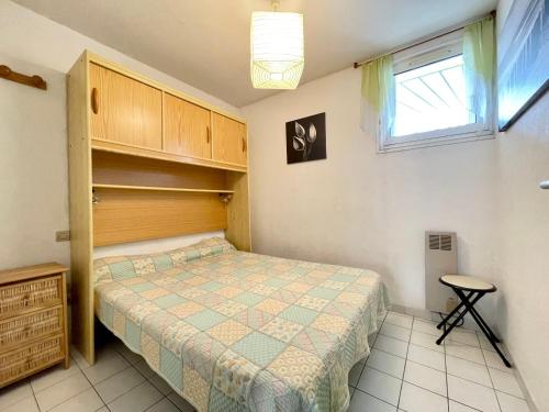une petite chambre avec un lit et une fenêtre dans l'établissement Appartement 2 pièces climatisé avec parking, à 150m de la plage et proche commerces, Séte - FR-1-338-565, à Sète