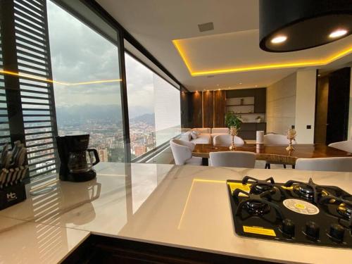 a kitchen and living room with a view of the city at penthouse luxurytravelhome poblado in Medellín