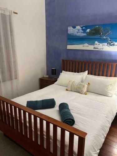 a bed with two pillows on it in a bedroom at Cosy Home in Heart of Subiaco in Perth