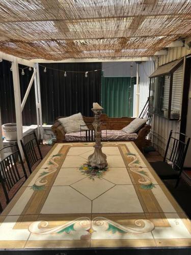 a living room with a table and a couch at Cosy Home in Heart of Subiaco in Perth