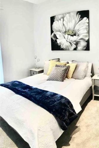 a bed with a blue and white blanket on it at Luxury Apartment London in London