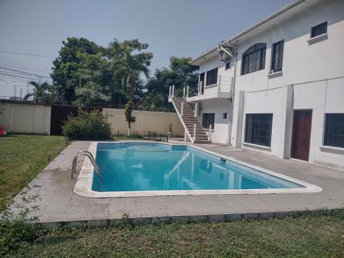 a swimming pool in front of a house at MATS in San Pedro Sula