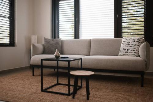 a living room with a couch and a table at VILLA Arte - just minutes from Mambo & Pietermaai in Willemstad