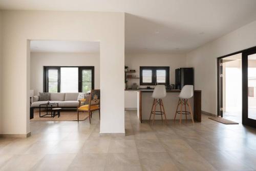 a living room with a couch and a table and chairs at VILLA Arte - just minutes from Mambo & Pietermaai in Willemstad