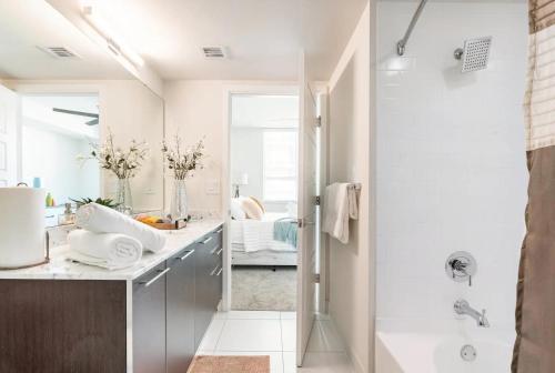 a bathroom with a walk in shower and a sink at Luxury- 2BR in Channel Side - downtown Tampa in Tampa