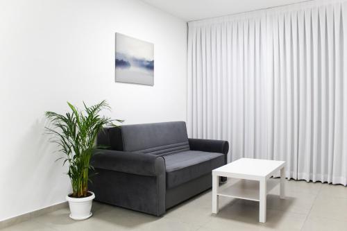 a living room with a couch and a table at Luxury Family Apartment #28 By Hashdera Eilat in Eilat