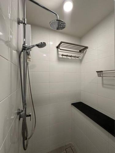 a bathroom with a shower with a shower head at Cozy,convenient,shopping area in Chiang Mai
