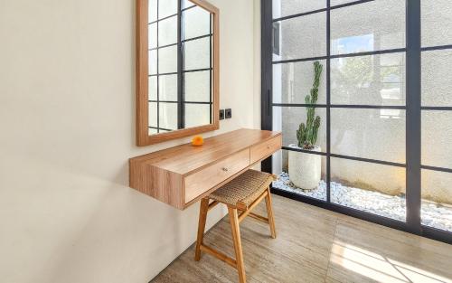 a wooden desk in a room with a window at Dandelion Villas Pandawa by Nagisa Bali in Badung