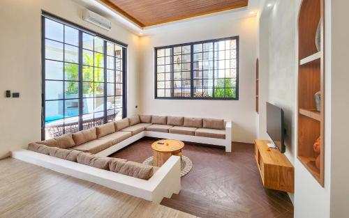 a living room with a couch and a tv at Dandelion Villas Pandawa by Nagisa Bali in Badung