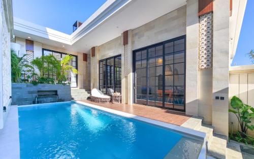 an indoor swimming pool in a house at Dandelion Villas Pandawa by Nagisa Bali in Badung