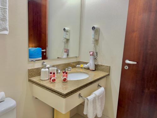 a bathroom with a sink and a mirror at Hotel - São Paulo AV Paulista in São Paulo