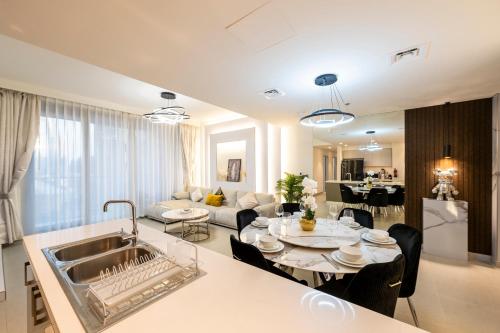 a kitchen and living room with a table and a sink at 3 Bedrooms Forte tower 1- Downtown Skylight in Dubai