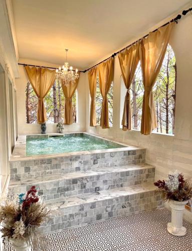 a swimming pool in a house with windows at Villa PaSon in Khao Kho