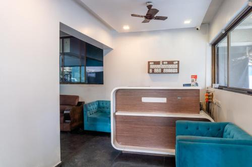 a living room with a couch and a ceiling at Treebo Blossom - Viman Nagar in Pune