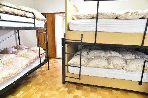 a room with two bunk beds and a wooden floor at Greenheim Suitengushita / Vacation STAY 1689 in Otaru