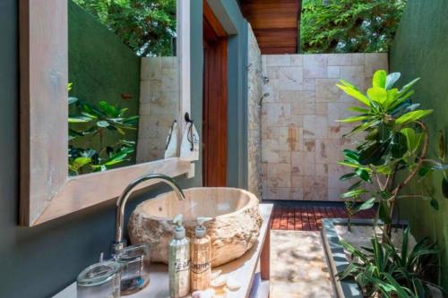 a bathroom with a sink and a mirror at Ammora 1 BR Deluxe Suite NE60 in Gili Air