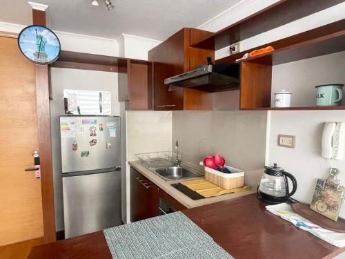a kitchen with a stainless steel refrigerator and a sink at Casa de Moneda Downtown in Santiago