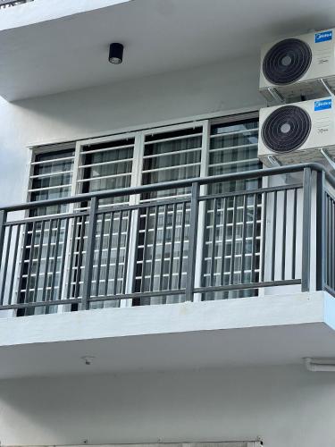 a balcony with a metal railing and a window at AARON MARUDU HOMESTAY in Kampong Sorosob