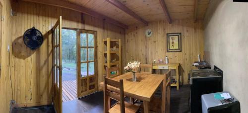 a kitchen with a wooden table and a dining room at Jasy del monte in Leandro N. Alem