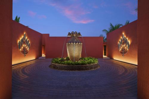 a courtyard with a fountain in the middle of a building at Storii By ITC Hotels Devasom Resort & Spa, Kolkata in Bāruipur