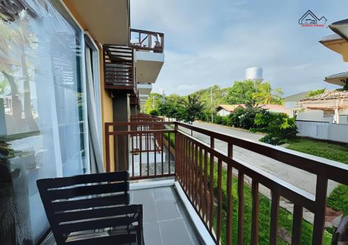 a balcony with two chairs and a view of a street at Best Pet-Friendly Condo Near Puerto Princesa Airport - B2 6Diamond in Puerto Princesa City