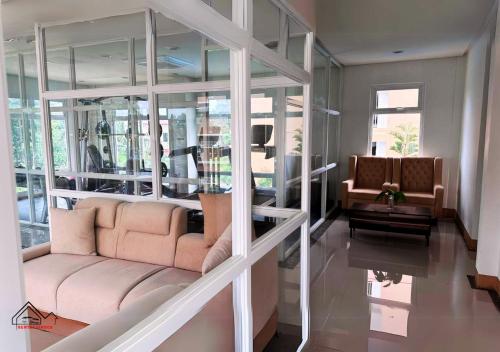 a living room with a couch and a table at Best Pet-Friendly Condo Near Puerto Princesa Airport - B2 6Diamond in Puerto Princesa City