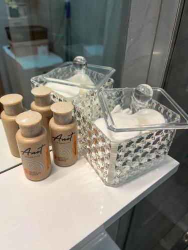 a counter with three bottles and a basket on it at Apartman Malena in Trebinje