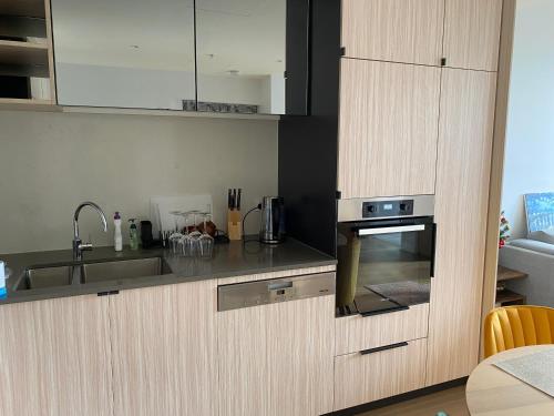 a kitchen with a sink and a stove at Darling Harbour 2b apt Car space upon request ICC CBD family friendly with view in Sydney