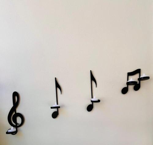 a group of music notes on a white wall at Dreamy Luxury Studio in Nafpaktos