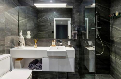 a bathroom with a sink and a shower and a toilet at Large Studio in the heart of Hope Island & Sanctuary Cove in Gold Coast