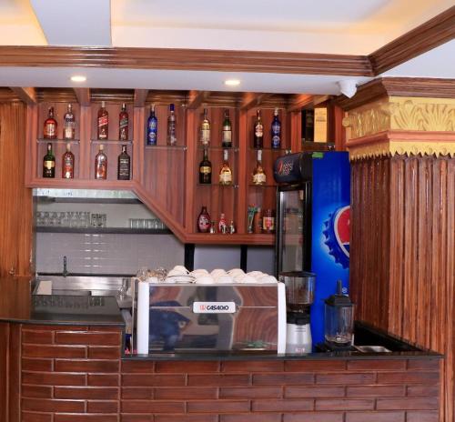 a bar with bottles of alcohol on the wall at Satkar Hotel and Spa in Kathmandu