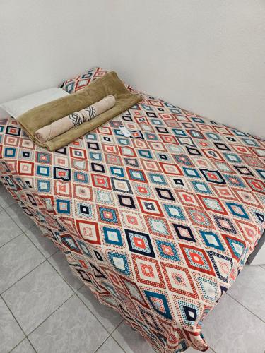 a bed with a colorful blanket on top of it at Rivera Casa mía in San Miguel