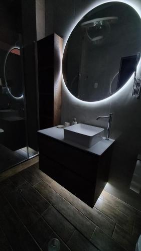 a bathroom with a sink and a mirror at Jardines de Milé in Laredo Hacienda