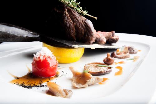a white plate with food on it with a knife at Hotel Downtown in Sofia