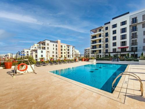 a swimming pool in the middle of a building at Splendid brand new 1BD apartment near the beach in Dubai