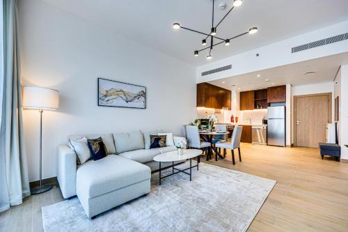 a living room with a couch and a table at Splendid brand new 1BD apartment near the beach in Dubai