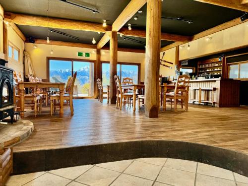 a dining room with a table and wooden chairs at Place yatsugatake Lodge&cottage in Hokuto