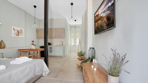 a white room with a bed and a table at Lefkada Historical Charm in Lefkada Town