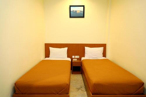two beds in a small room with at ion hotel in Batam Center