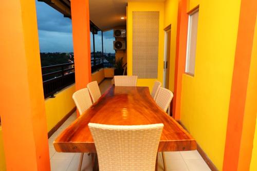 y balcón con mesa y sillas de madera. en ion hotel en Batam Center