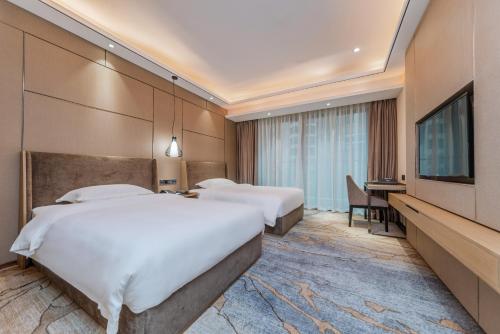 Katil atau katil-katil dalam bilik di Meihao Lizhi Hotel Guangzhou Nansha Tianhou Temple Branch