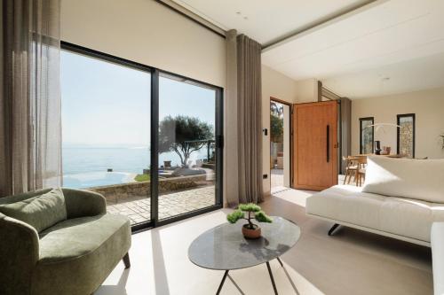 a living room with a couch and a table at Nisos Villa Emerald in Kornáta