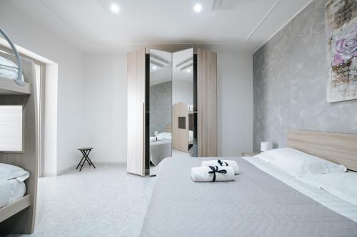 a bedroom with a large bed with two towels on it at Gioema in Borgo Vodice
