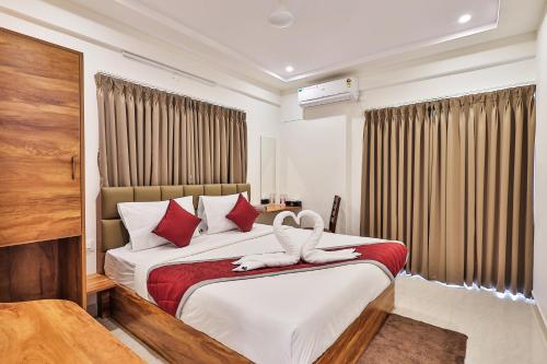 a bedroom with a bed with a swan on it at The Auberge Boutique Hotel - Manyata Tech Park in Bengaluru