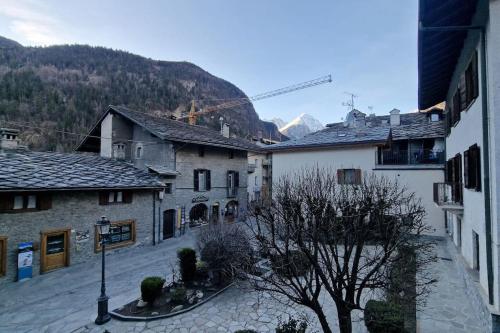 a view of a town with buildings and a tree at Coeur de Valdigne in Morgex