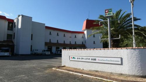 un edificio con un cartello di fronte a un parcheggio di HOTEL GREEN PLAZA SHODOSHIMA - Vacation STAY 71488v a Ikisue