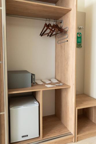 a closet with a wooden shelf and a box at Pension a und a in Vienna