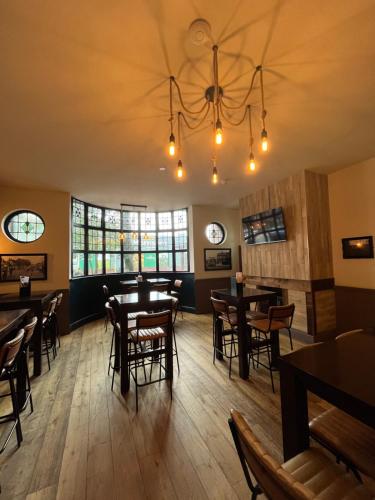 a dining room with wooden tables and chairs at The Bournbrook Inn in Birmingham